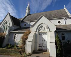 The Holy Trinity Anglican Church and Coulter Cross in Kokstad's Main Street.