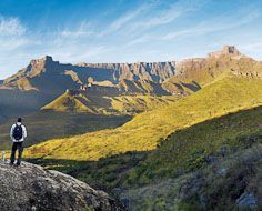 Hiker's take in the view of the Amphi Theatre in the Northern Drakensberg of KwaZulu-Natal - South Africa.