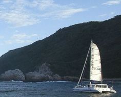 The Heads Explorer sailboat between the Knysna Heads, in the mouth of the Knysna Estaury.