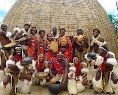 Men and women in traditional dress at Kruger Cultural Village in South Africa.