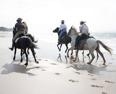 Horse-riding on the beach near St. Lucia on the KwaZulu-Natal North Coast.