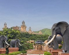 'The Bridge of Time' flanked by huge elephant statues at the Sun City Resort in the North-West Province. In the distance is visible The Palace of The Lost City Hotel.
