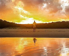 A visitor enjoys the sunset on a deserted beach at Qolora Mouth on the Wild Coast.