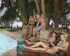 Kids enjoying the swimming pool at the Wild Coast Sun with the Indian Ocean in the background.