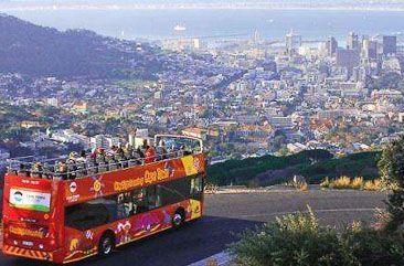A Citysightseeing open-top bus above Cape Town