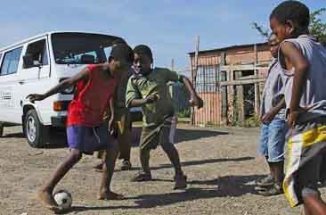 Township kids playing street soccer