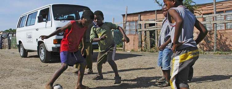 Township kids playing street soccer